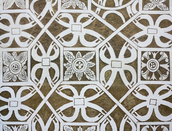 How can you use period-appropriate textiles in a UK Tudor revival bedroom?