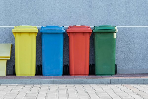 How do you effectively manage waste recycling systems in a multi-unit UK housing complex?