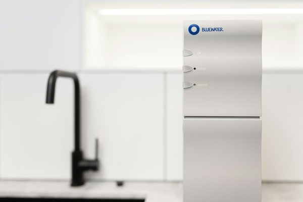 How can residents improve water quality using at-home filtration systems in UK hard water areas?