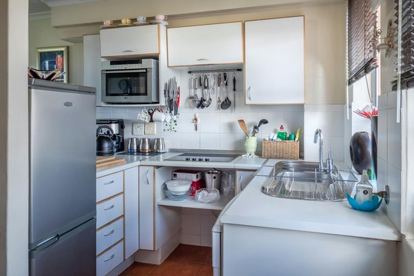 How can you maximize space in a small UK flat kitchen while ensuring sufficient storage?